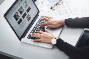 Person typing on a mac book