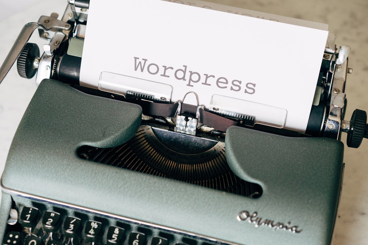 Typewriter with a piece of paper inside spelling 'WordPress'
