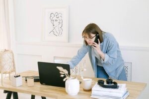 A woman talking on the phone in her office