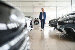 man walking through car showroom
