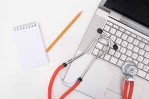 stehescope on lap top notepad 