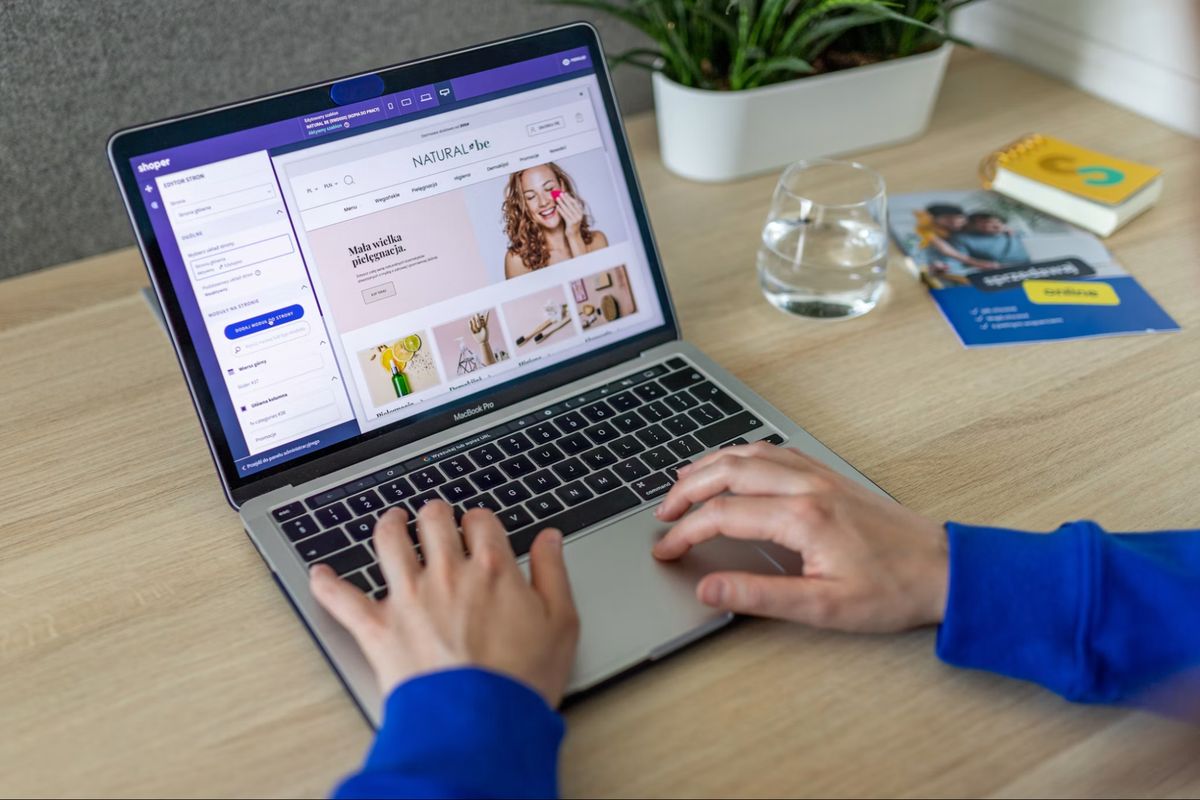 Store owner editing an online store page on a laptop