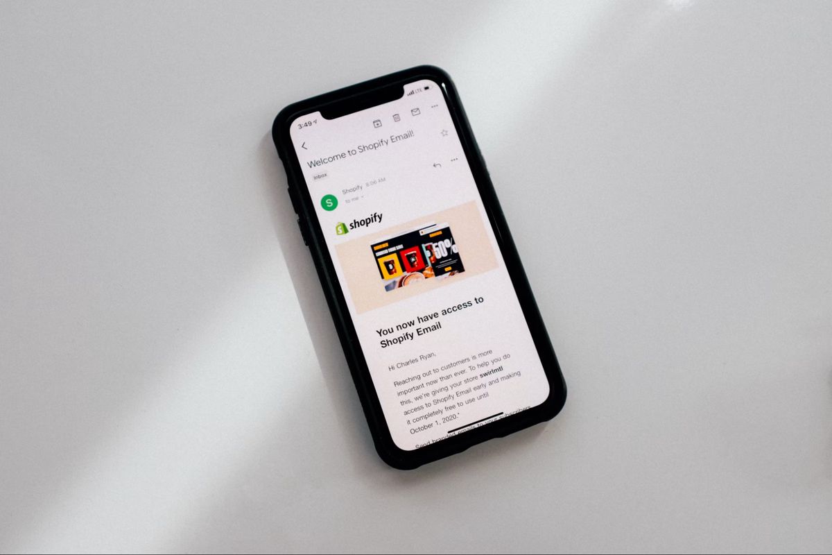 Phone showing a Shopify email in the inbox