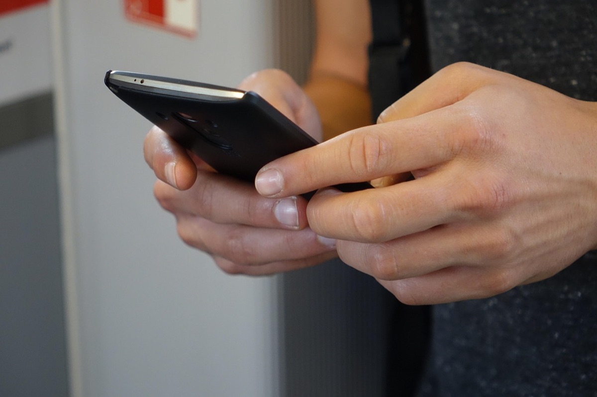 Person typing on a smartphone