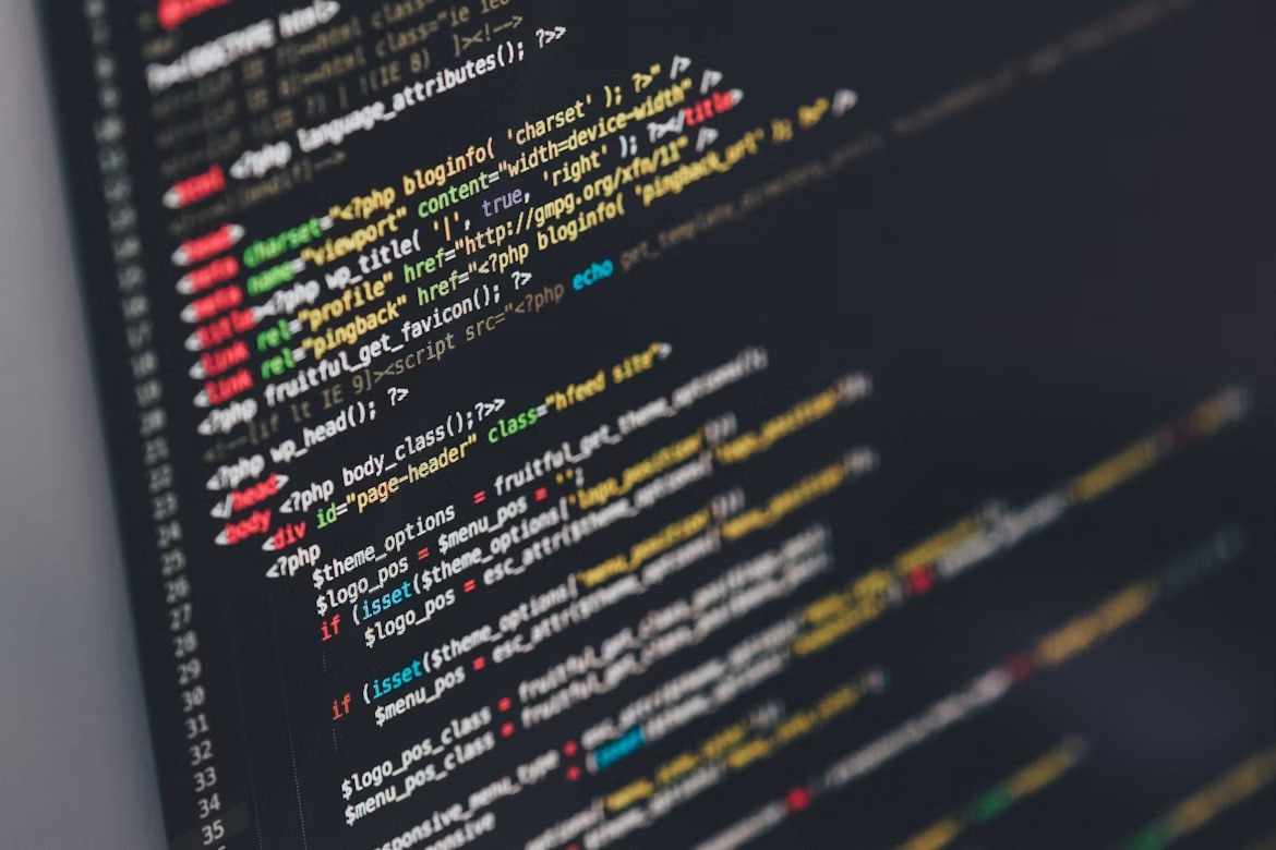 Lines of web application code on a dark screen